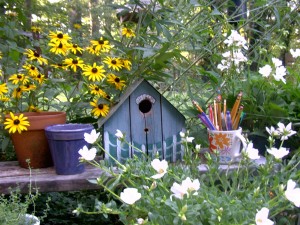 Birdhouse and flowers and pencils